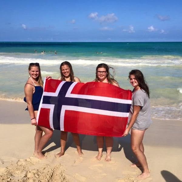 Exchange students on a beach representing their home country of Norway