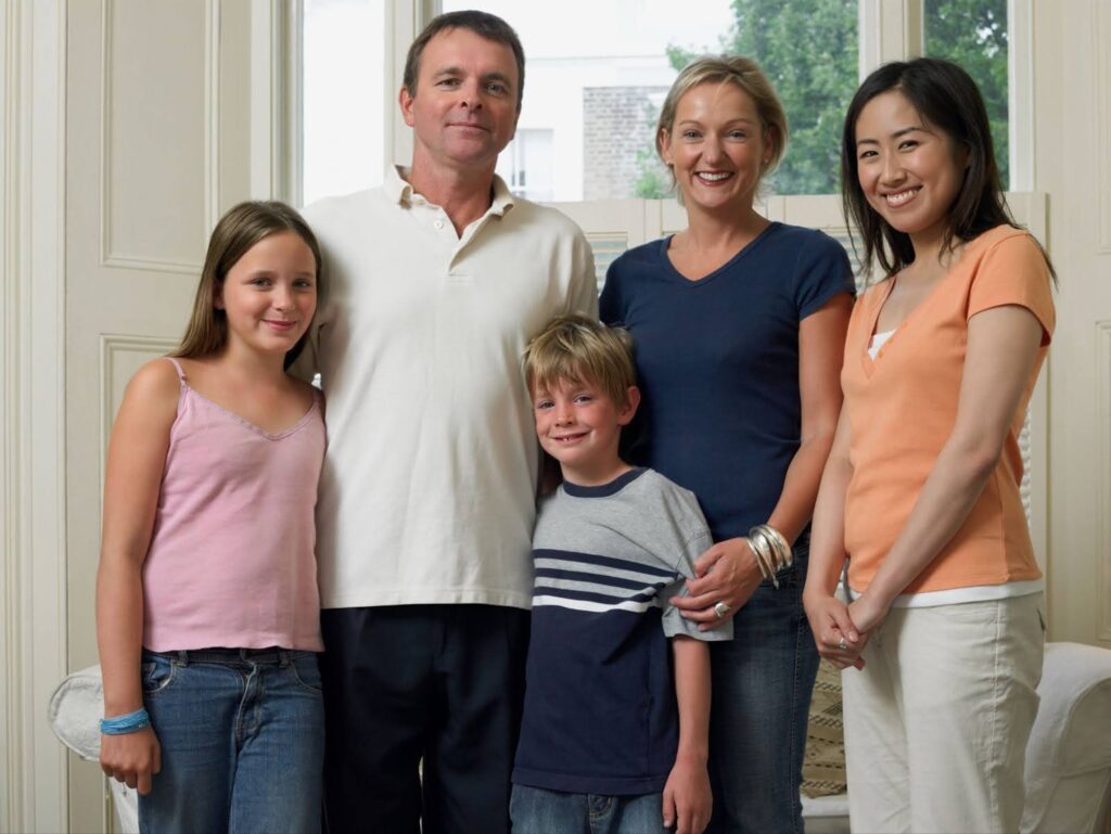 Japanese exchange student taking group photo with her American host family