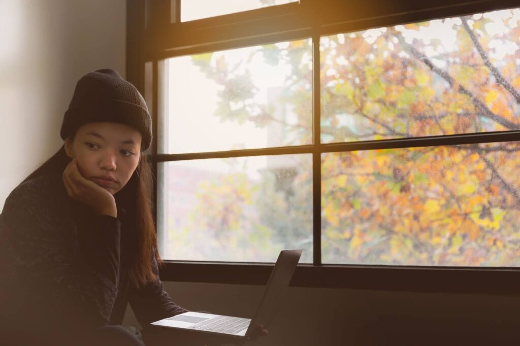 Asian girl dealing with homesickness while studying abroad