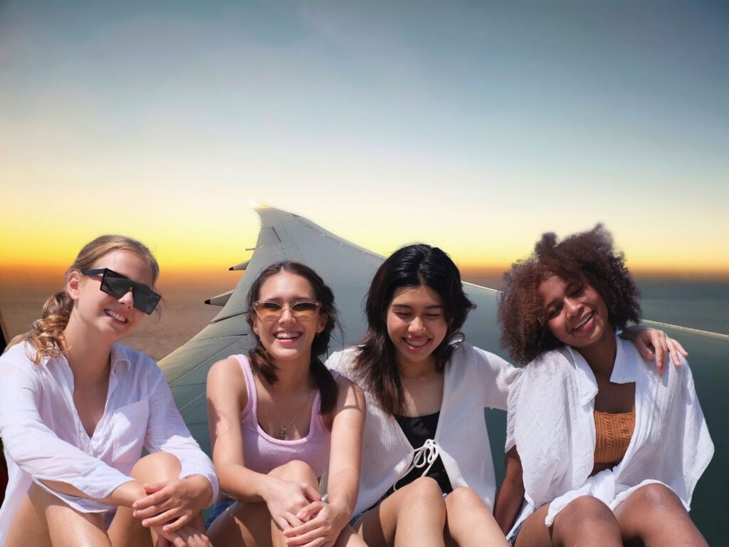 Study abroad female friend group pictured on airplane wing