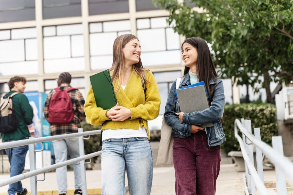 Two international exchange students chatting together on campus