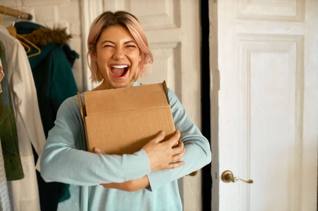 Cheerful foreign exchange student receiving gift from host family